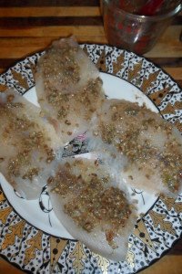 Raw fish with caper paste topping.