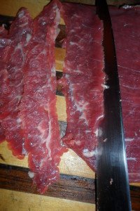 Cutting the steak across the grain.