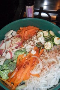 Sliced vegetables in pan on stove.