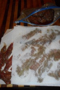 Drying the meat off with paper towel.