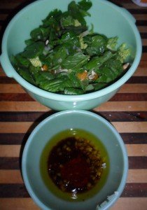 Mixing ingredients for dressing alongside salad.