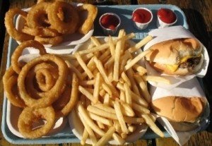 School lunch tray with fries, onion rings, and burgers.