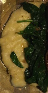 Wilted spinach served on polenta.