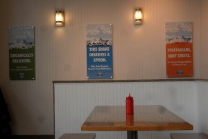 Signs on the wall about vegetarian, organic, and milkshakes.
