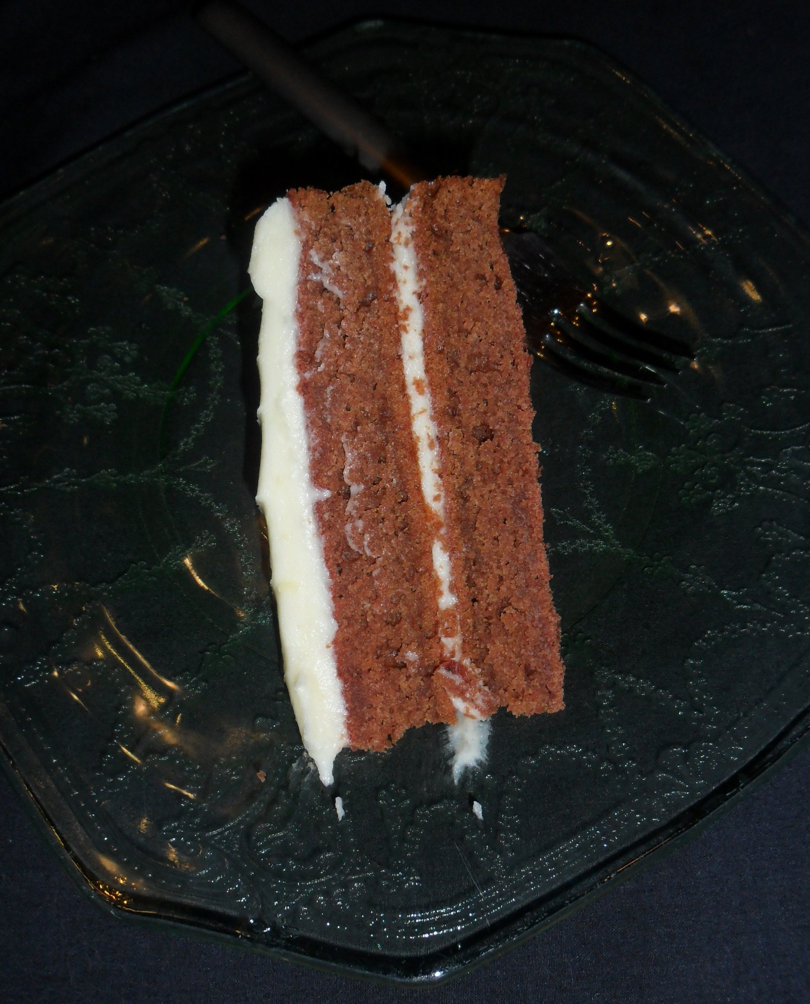 Serving a slice of red velvet cake.