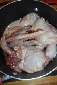 Chicken pieces in a pot.