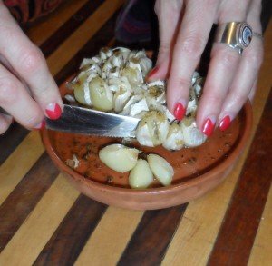 Removing roasted garlic cloves from head.