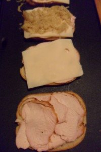 Three sandwiches in different stages.