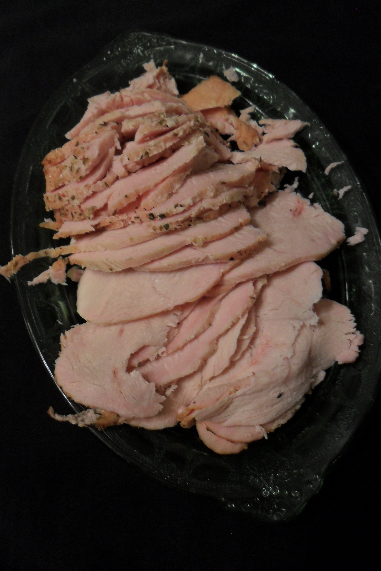 Sliced roasted turkey breast on platter.