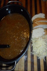 Soup, cheese, and French bread slices.