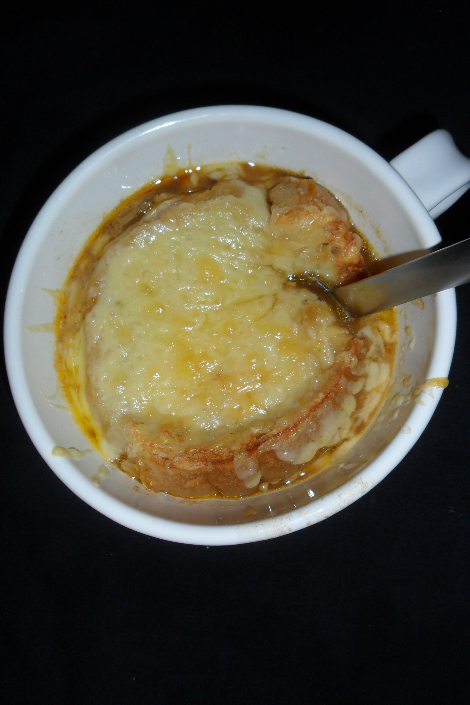 Serving French onion soup.