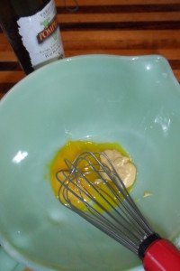 Whisking the egg yolk and mustard.