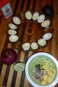 Eggs ready to fill and bowl with ingredients.