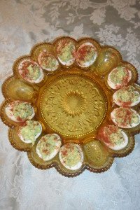 Green eggs on deviled egg serving plate.