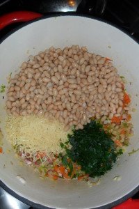 Adding beans and herbs.