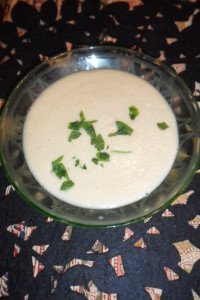 Serving cauliflower soup with parsley garnish.