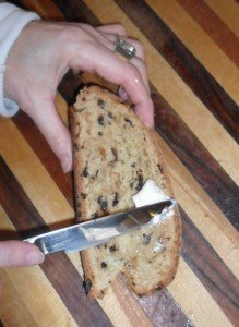 Buttering a piece of soda bread.