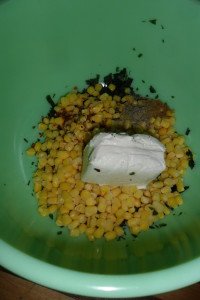 Corn, cream cheese, and spices in bowl.