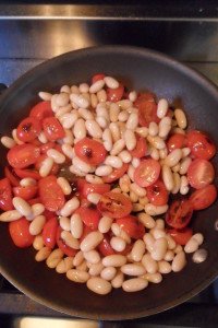 Sautéing the tomatoes and beans.