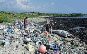 People standing on a plastic covered beach.