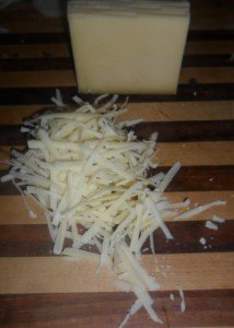 Grating Gruyere cheese.