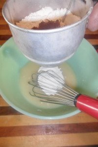 Sifting flour into milk mixture.