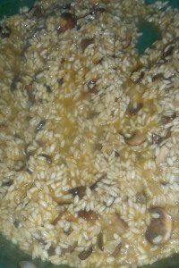 Stirring rice as broth starts to absorb.