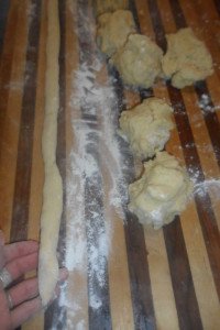 Long rope of dough next to 3 more balls.