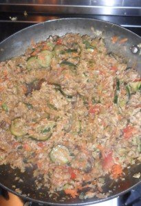 Finishing the stir-fry on the stove.