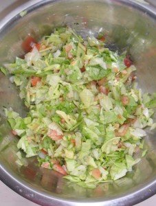 Tossing slaw ingredients.