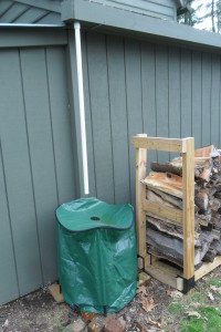 Shed barrel next to the wood pile.